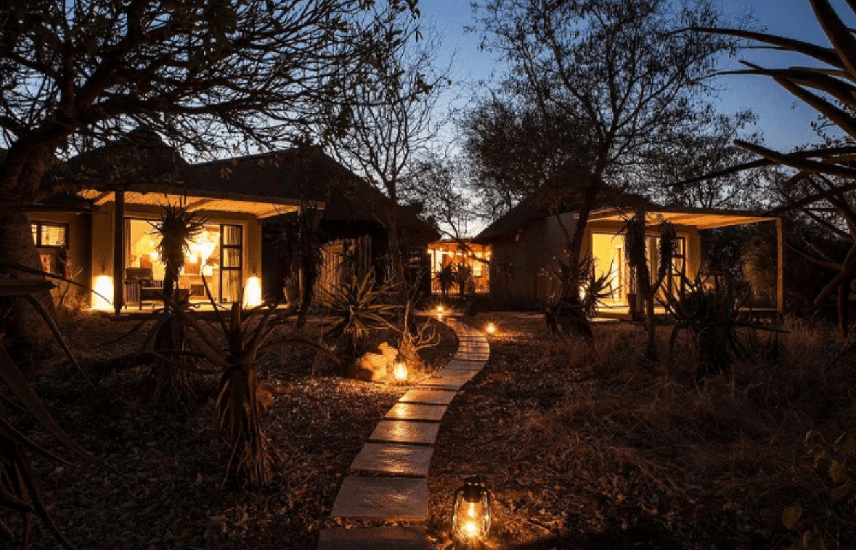 S002-IT1 - Lit Up Pathway Leading to Safari Lodge at Night Sustainable Safaris Africa - Journeys - Luxury Kruger Safari - Lit Up Pathway Leading to Safari Lodge at Night