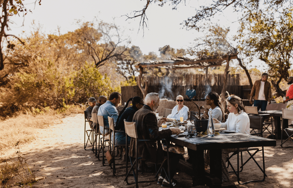 S002-IT2 - Guests on Safari Enjoying Lunch at Campsite ) Sustainable Safaris Africa - Journeys - Luxury Kruger Safari - Guests on Safari Enjoying Lunch at Campsite