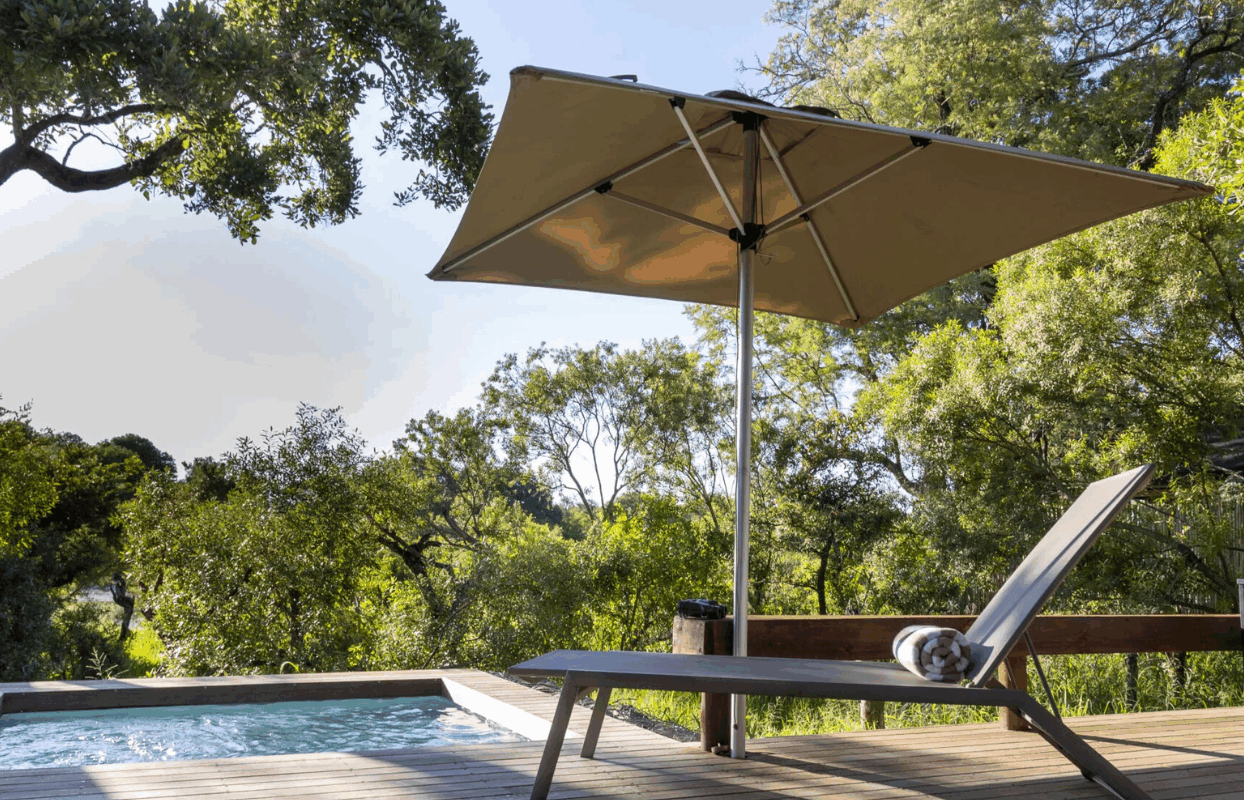 S003-IT2 - Umbrella and Lounging Chair at Accommodation Swimming Pool Sustainable Safaris Africa - Journeys - Family Friendly Kruger Safari - Umbrella and Lounging Chair at Accommodation Swimming Pool