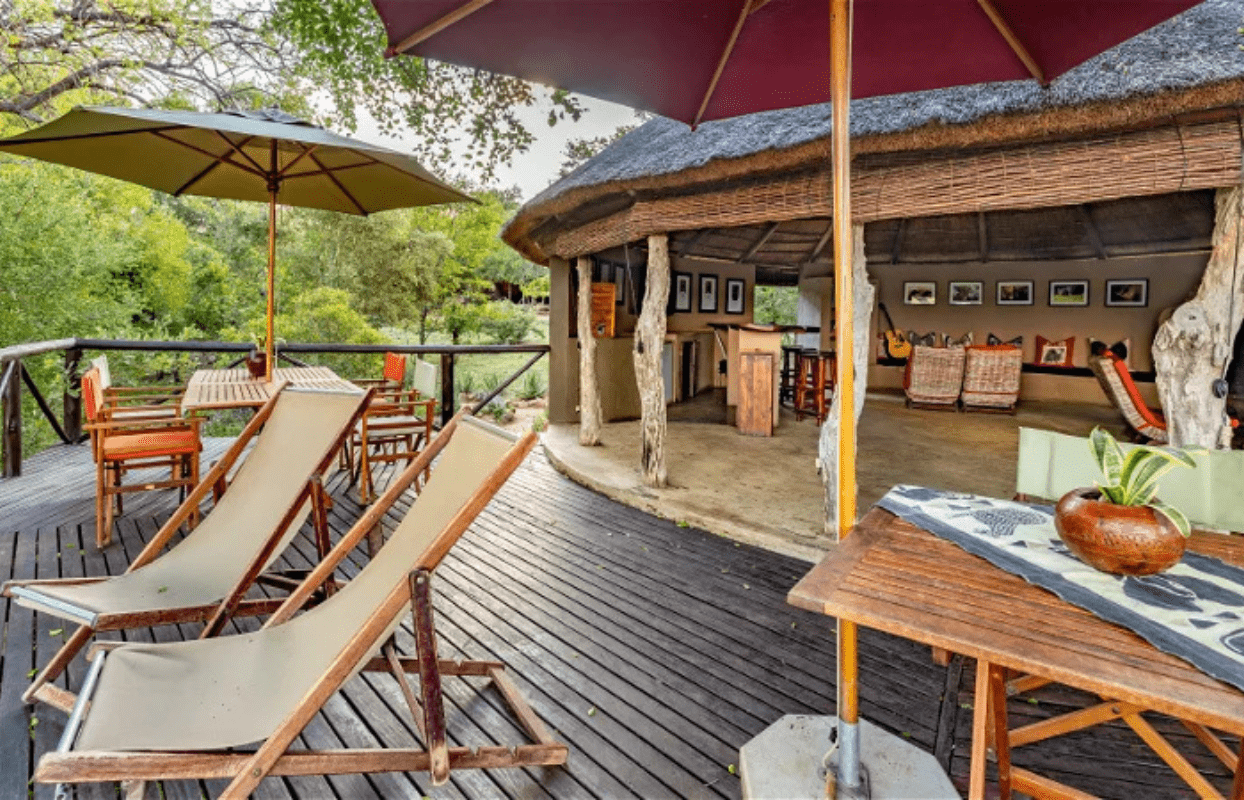 S003-IT1 - Bedroom Leading onto Outside Balcony and Chairs Sustainable Safaris Africa - Journeys - Family Friendly Kruger Safari - Bedroom Leading onto Outside Balcony and Chairs