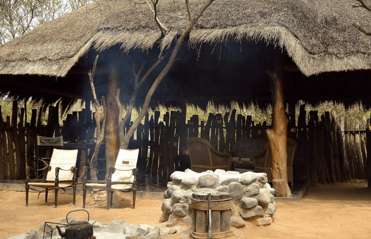 S004 - IT2 - Thatch Roof Safari Hut and Lounging Chairs by The Firepit Sustainable Safaris Africa - Journeys - African Glamping Safari - Thatch Roof Safari Hut and Lounging Chairs by The Firepit