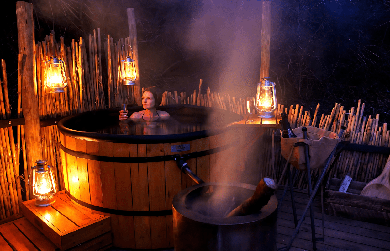 S004 - IT2 - Woman on Safari Relaxing in Hot Tub at Safari Lodge Sustainable Safaris Africa - Journeys - African Glamping Safari - Woman on Safari Relaxing in Hot Tub at Safari Lodge